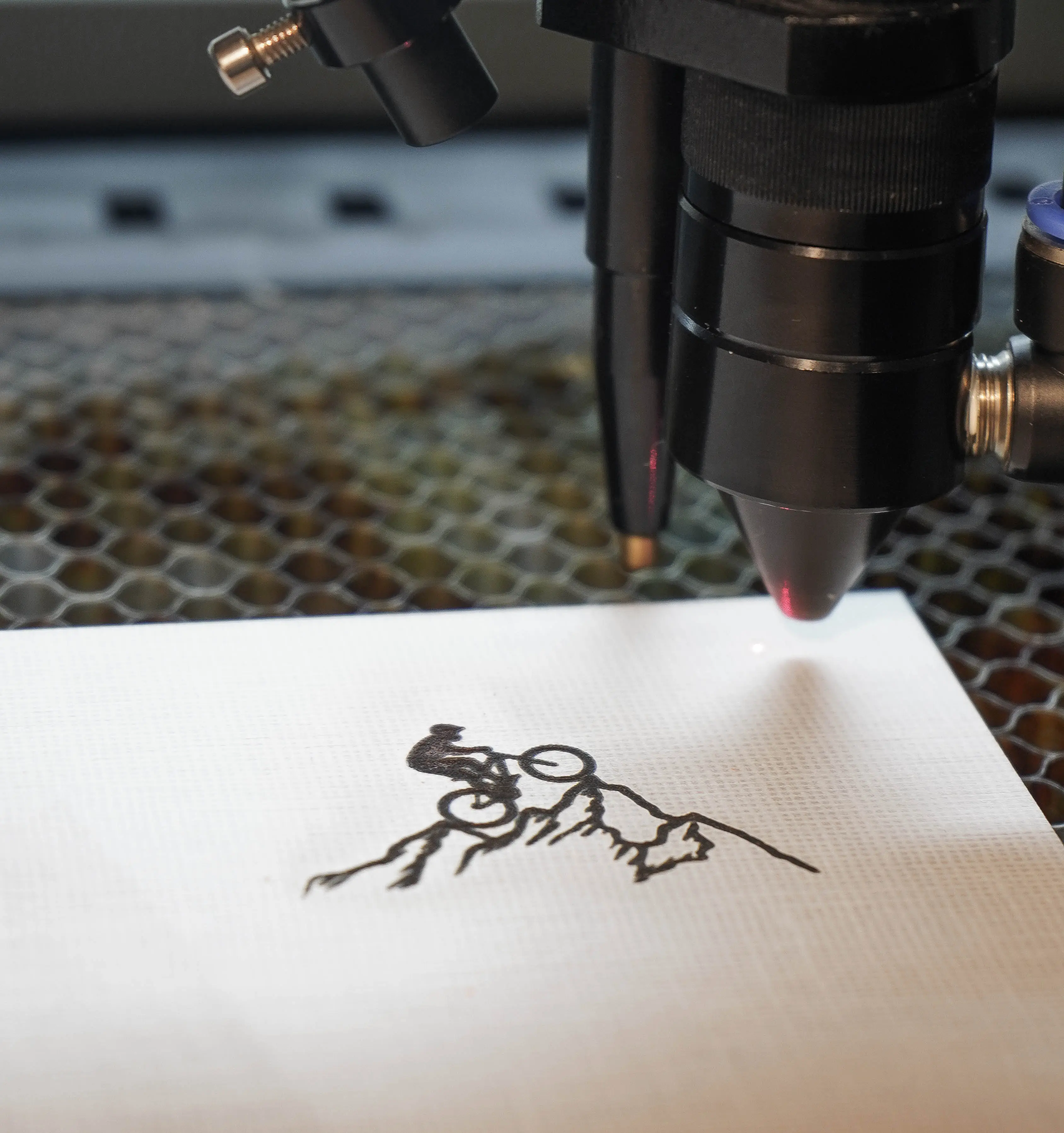 Close-up of laser engraving a custom design onto wood