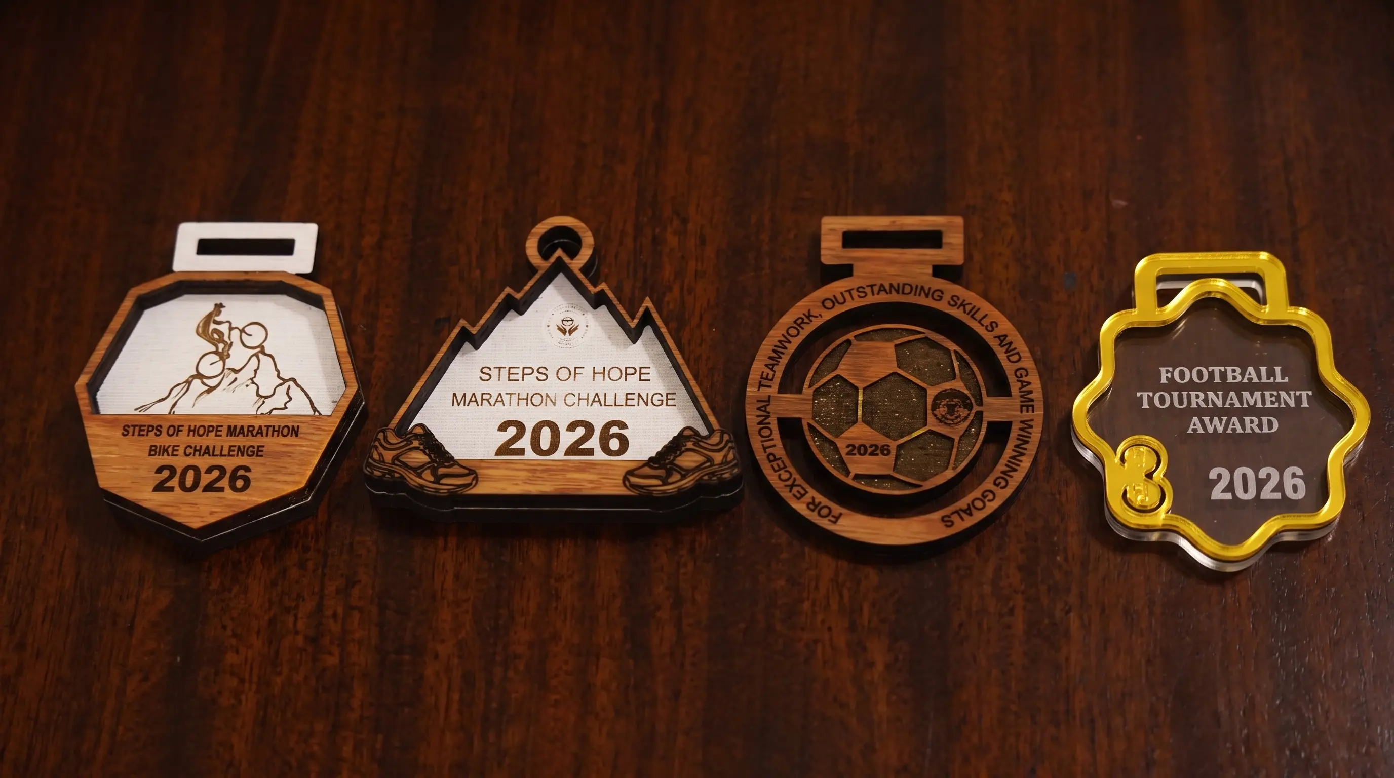 Custom KORA medals laid out on wood